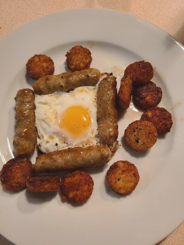 I poached an egg in a cast iron pan using breakfast sausages as a frame.