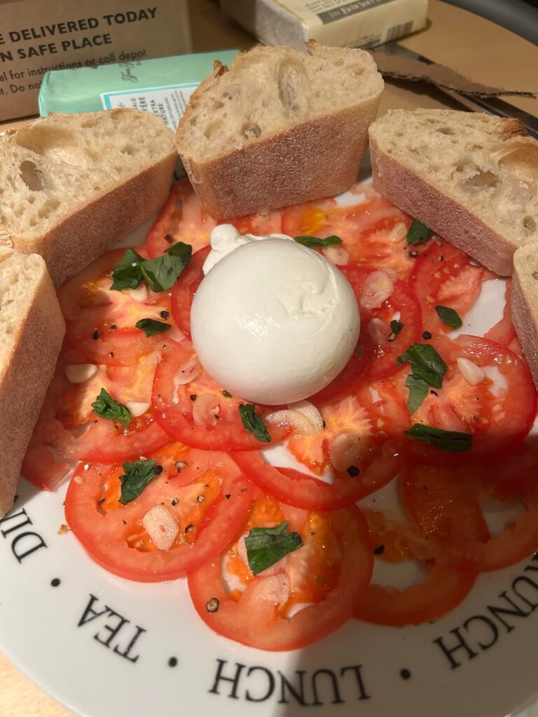 Burrata with garlic and basil tomatoes and baguette. Deliciously simple.