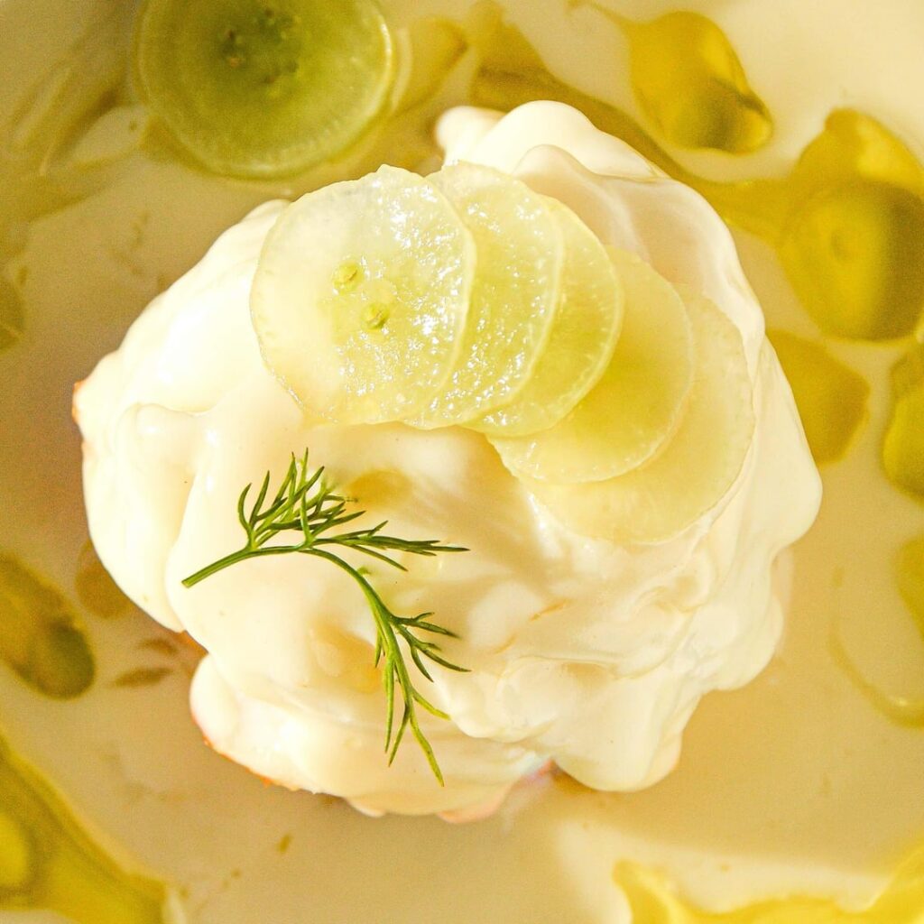 Cod Véronique - poached fillets with fish based velouté, white grapes, and basil oil