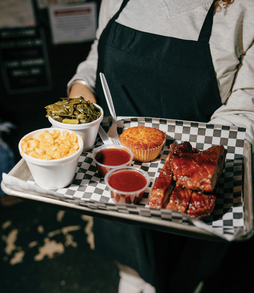 a platter of ribs, mac and cheese, green beans, and corn bread from Daddy D’z BBQ Joynt