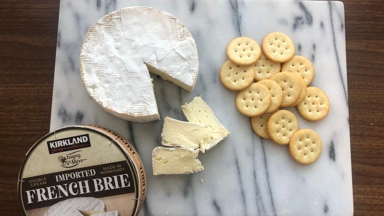 Kirkland Signature brie on platter with crackers.