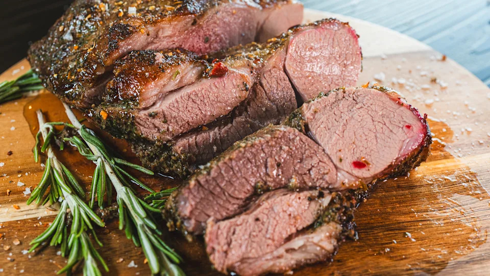 Freshly sliced, succulent roasted leg of lamb