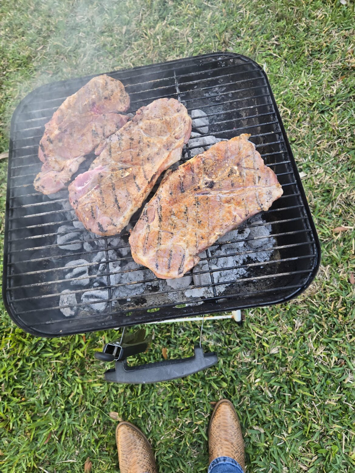 Pork steaks on the grill.