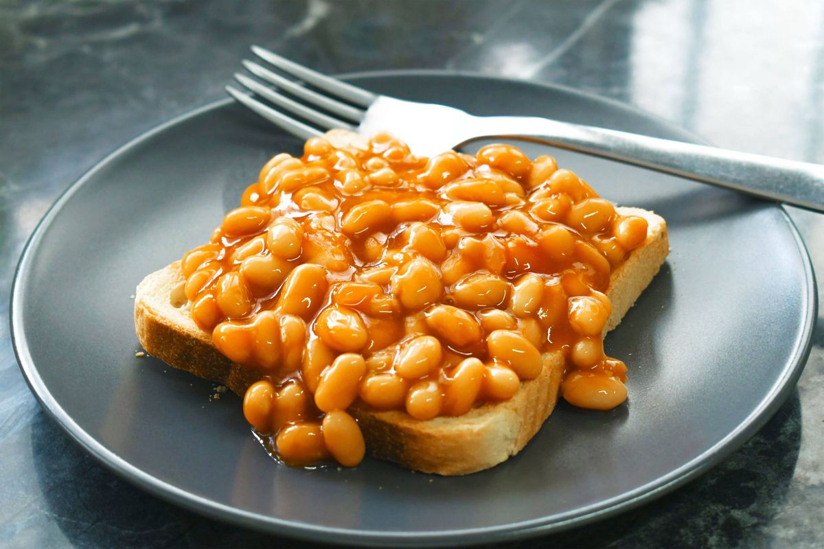 Beans on toast with fork on a plate.
