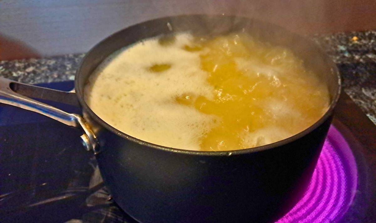 Picture of a pot of rice boiling in water