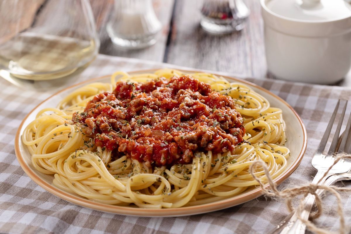 High angle view of spaghetti bolognese on wooden table