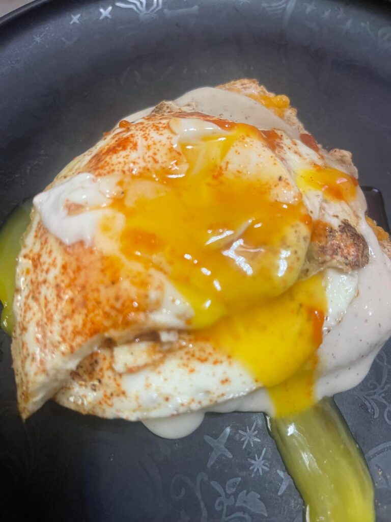 Breakfast this morning! Cheesy toast with gravy, 2 sunny side up eggs, sriracha and syrup! I love my eggs gooey!