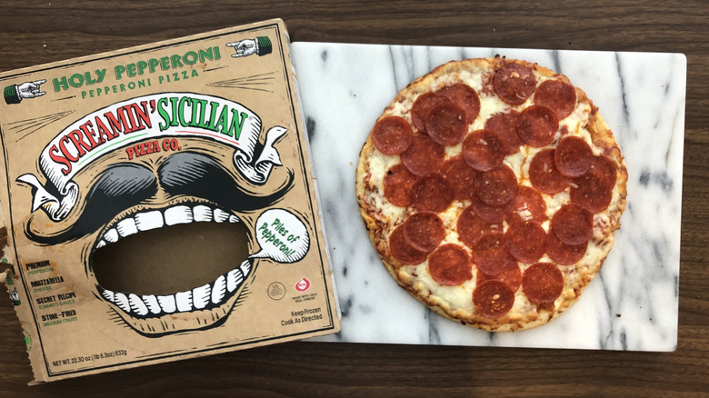 Screamin' Sicilian Holy Pepperoni pizza on a cutting board.