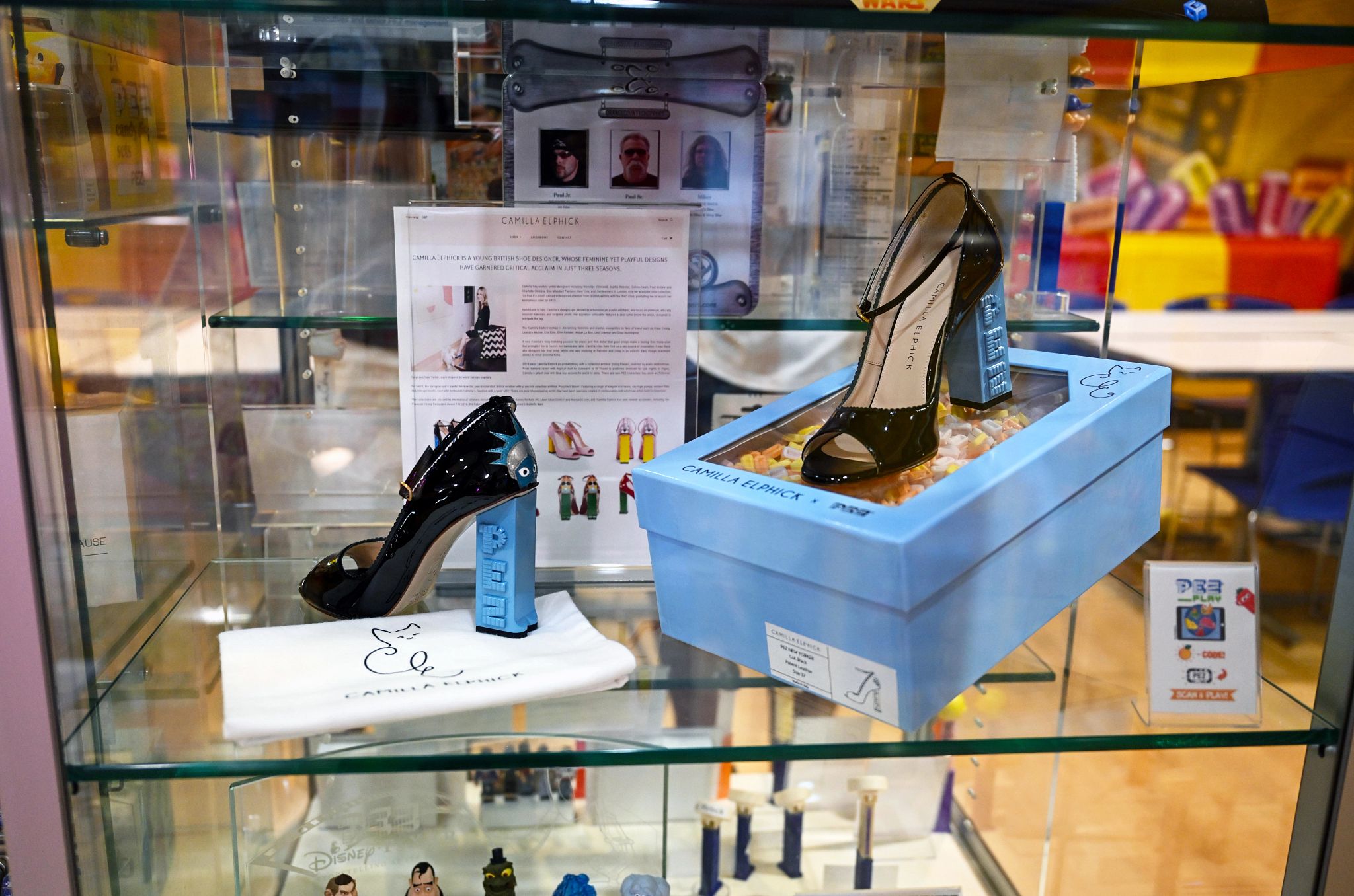 pez dispensers in the shape of shoes inside a glass case