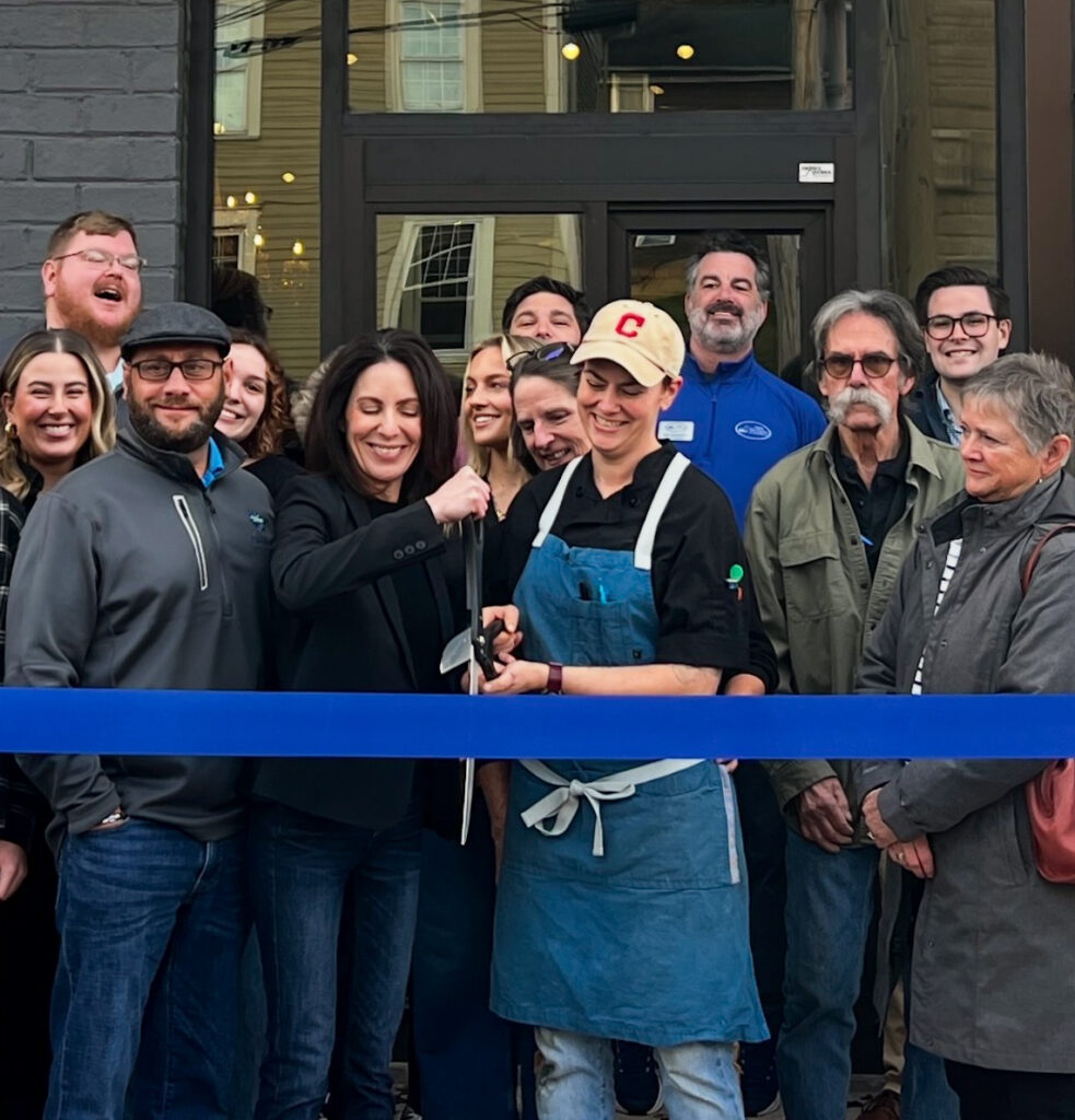 Co-owners Mandy Yannucci and Emily Hansford cut the ceremonial ribbon alongside friends, family and other attendees at their restaurant’s grand opening celebration on Nov. 19, 2025.