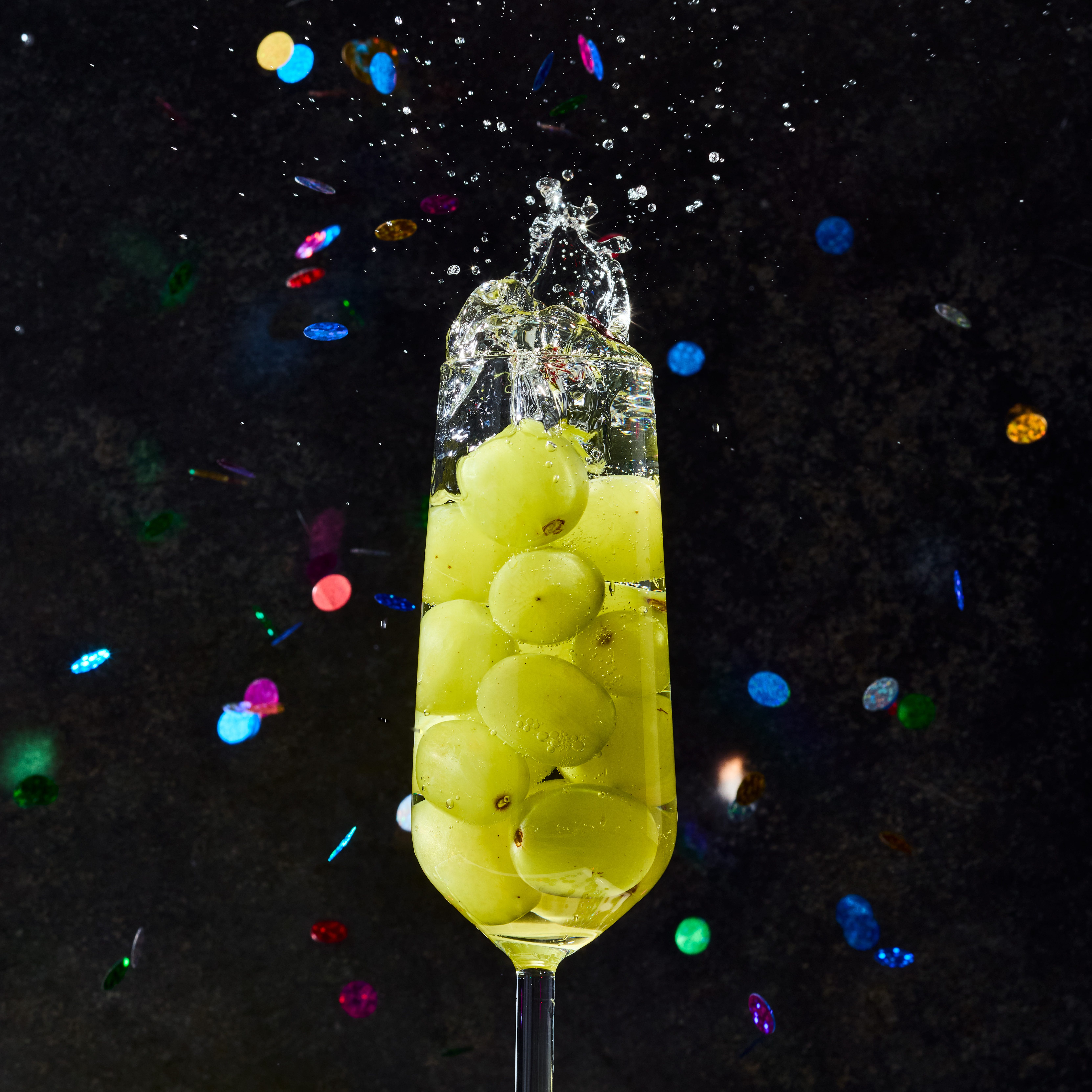 glasses of champagne filled with 12 green grapes