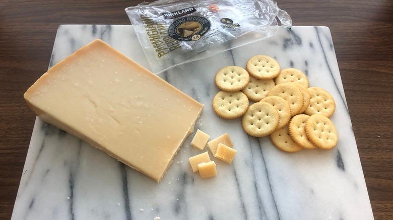 Kirkland Signature parmesan cheese on platter with crackers.