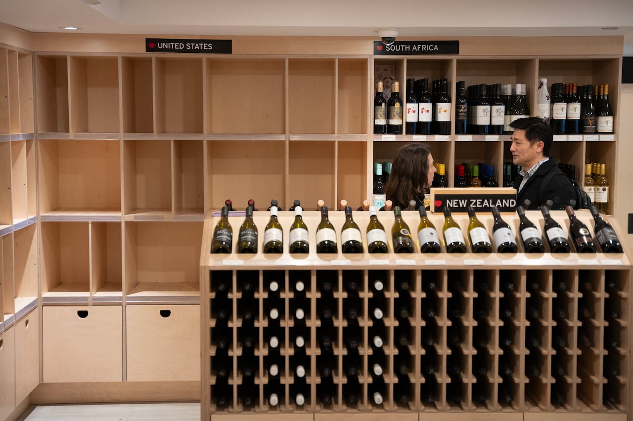 A liquor store with empty shelves under a sign that says U.S.