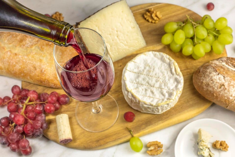 Red wine, cheese, bread and grapes at tasting