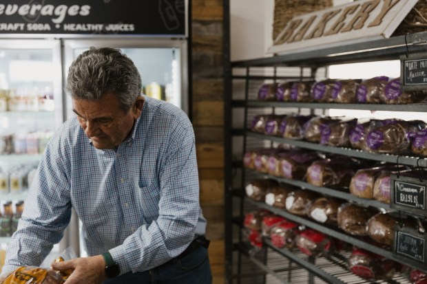 Michel Malécot sorts loaves of bread at Dudley's Bakery in Santa Ysabel, which he recently purchased with business partner Michael Brewer. (Kaliana Caldwell)