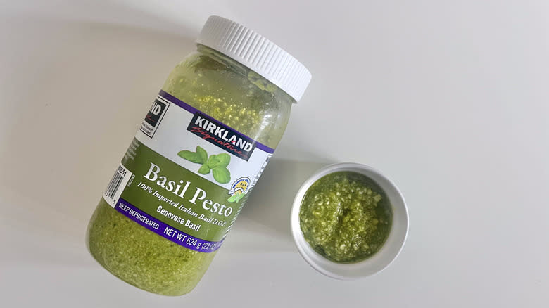 Kirkland Signature Genovese pesto with some scooped in a dish