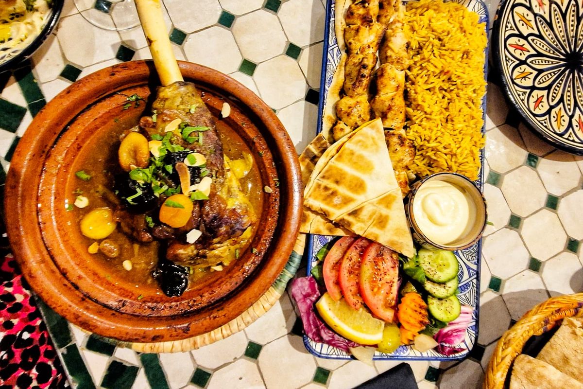 A dish of lamb tagine and chicken skewers with rice