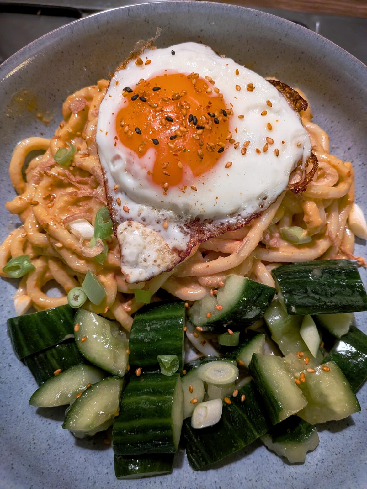 Peanut sesame noodles, smashed cucumber salad, and of course a fried egg