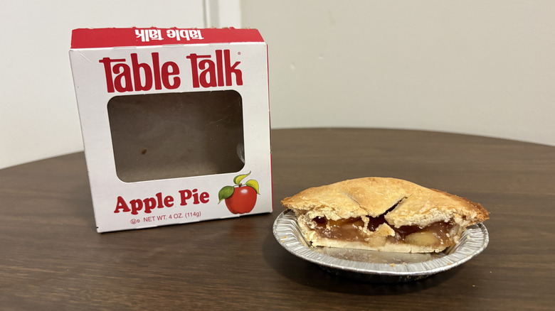 Table Talk apple pie box with the whole pie sliced in half on the side