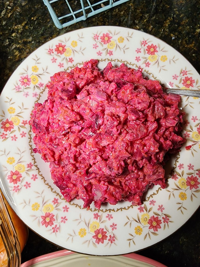 A plate of salad russe, a colorful Haitian salad made with local ingredients often eaten with a protein and fried green plantains. Photo by Guethshina Altena/The Haitian Times.

