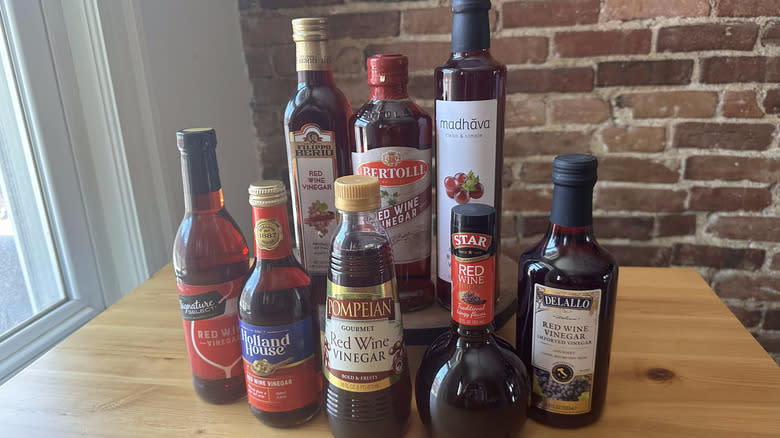 Red wine vinegar bottles on wooden table