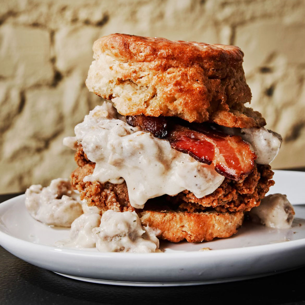 The biscuit piled with bacon, gravy and fried chicken is a must order. © Andrew Thomas Lee/Bomb Biscuit Co.