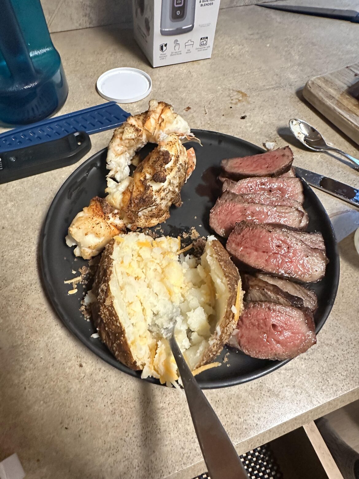 A5 Olive Wagyu(cooked) with de shelled South African lobster tail and a potato.