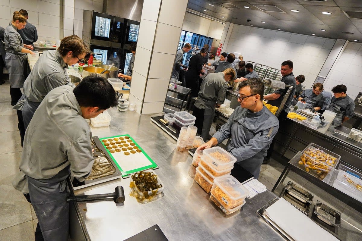 Chefs prepare the dishes inside the prep kitchen at restaurant Alchemist in Copenhagen, Denmark (AP)