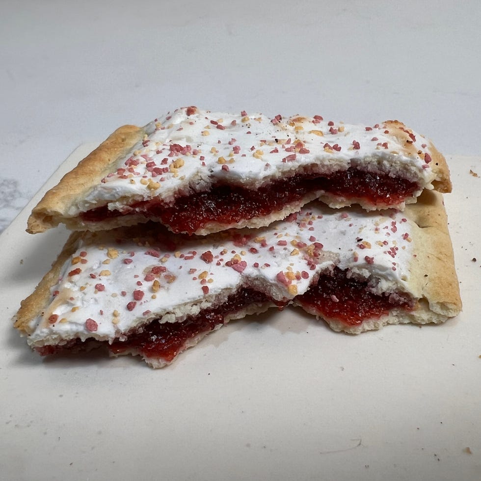 Sweet pastry filled with jelly and topped with frosting and sprinkles.