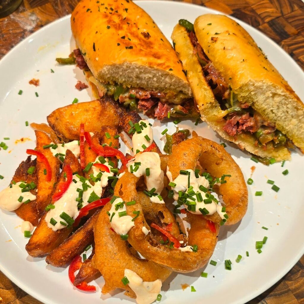 Vegan cheesesteak (juicy marbles), with loaded pickled onion rings and chips