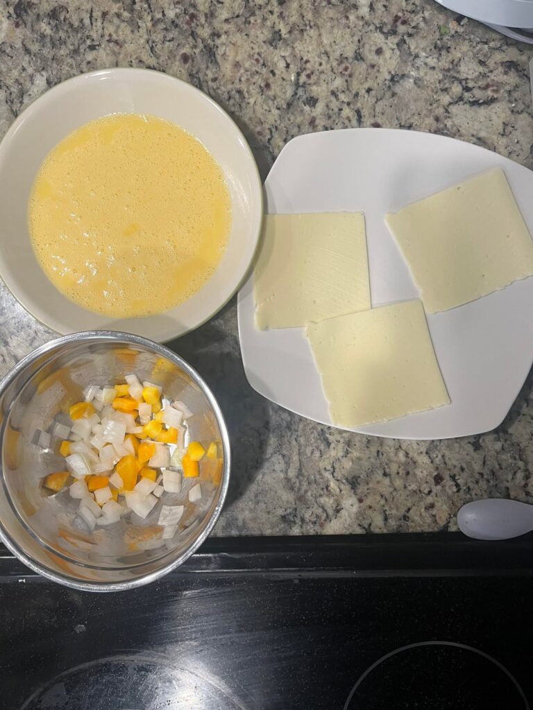 Eggs, peppers, onions and cheese. Side of bacon.