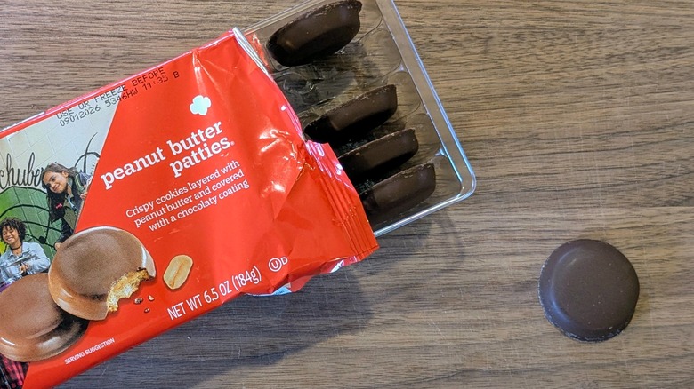 A package of Peanut Butter Patties next to one cookie outside of the package on a wood board