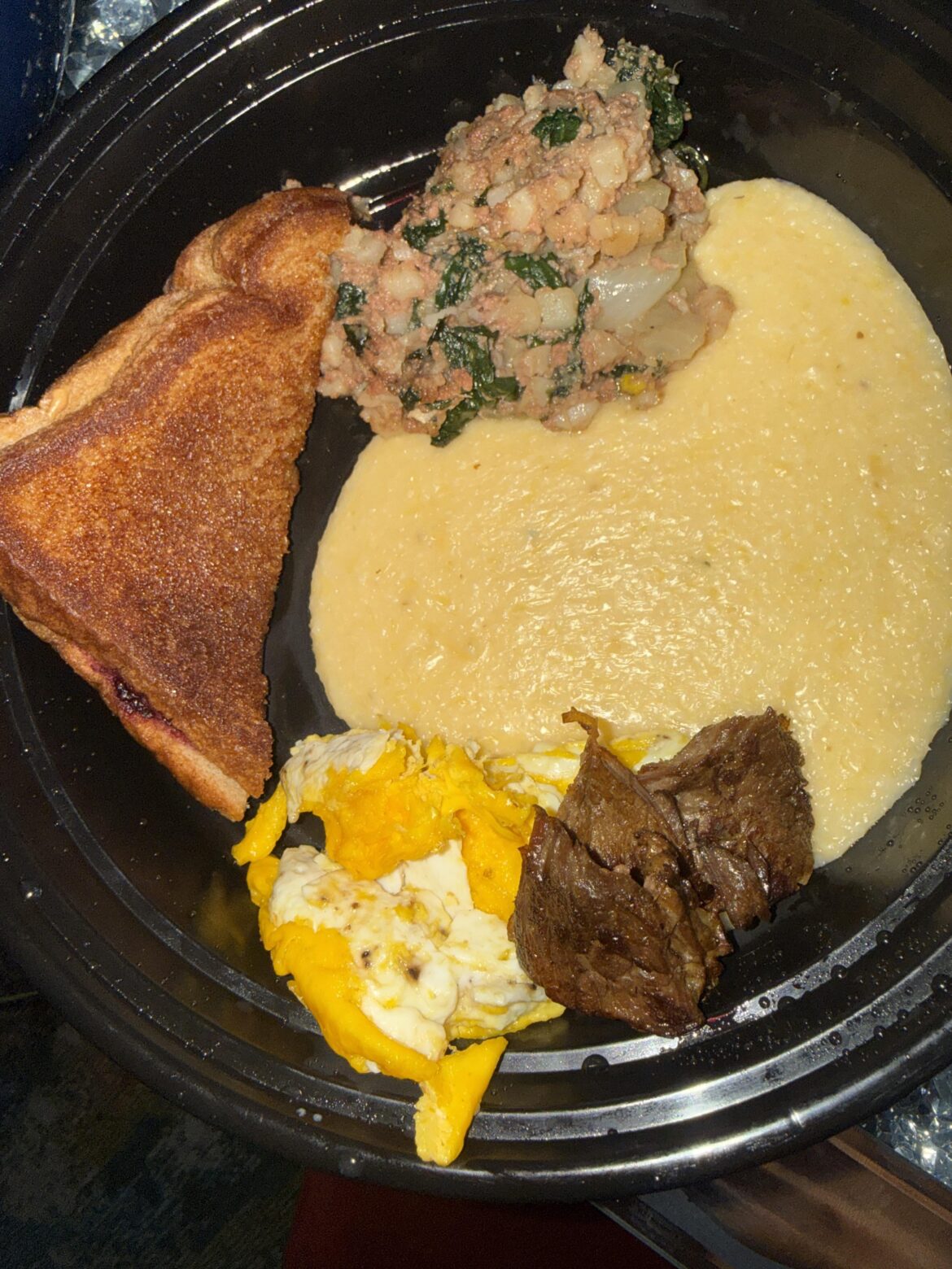 Toast corn beef hash and spinach grits scrambled eggs and steak