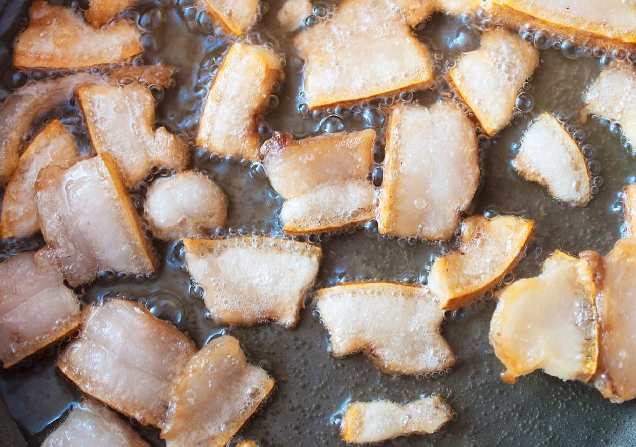 Fat fried in a pan. Best Ukrainian snack - greaves.Fat fried in a pan. Best Ukrainian snack - greaves.