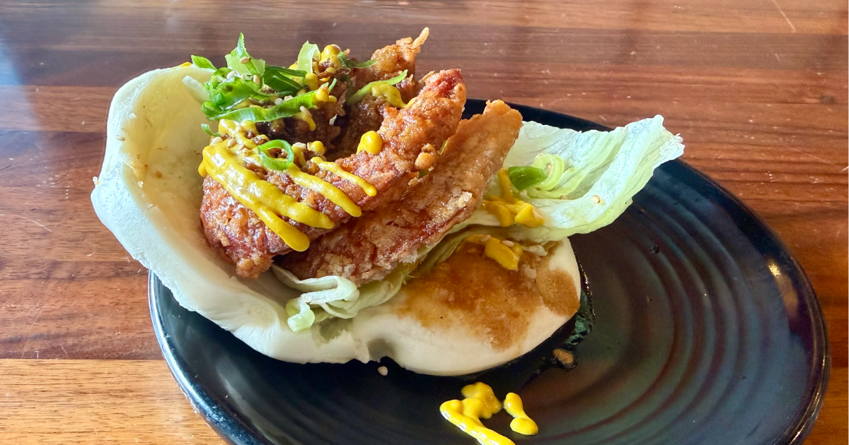 Looking down at a plate of Garlic Shrimp Bao Bun at Menya le Nood in Honolulu.