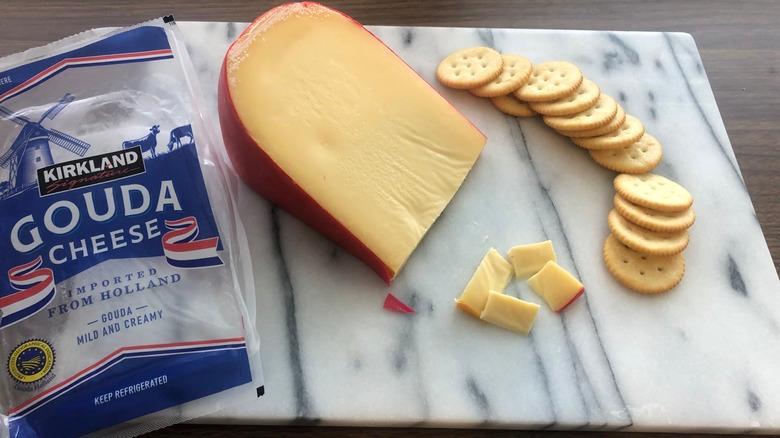 Kirkland Signature Gouda cheese on platter with crackers.