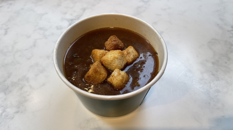 The French onion soup from Panera on a marble background