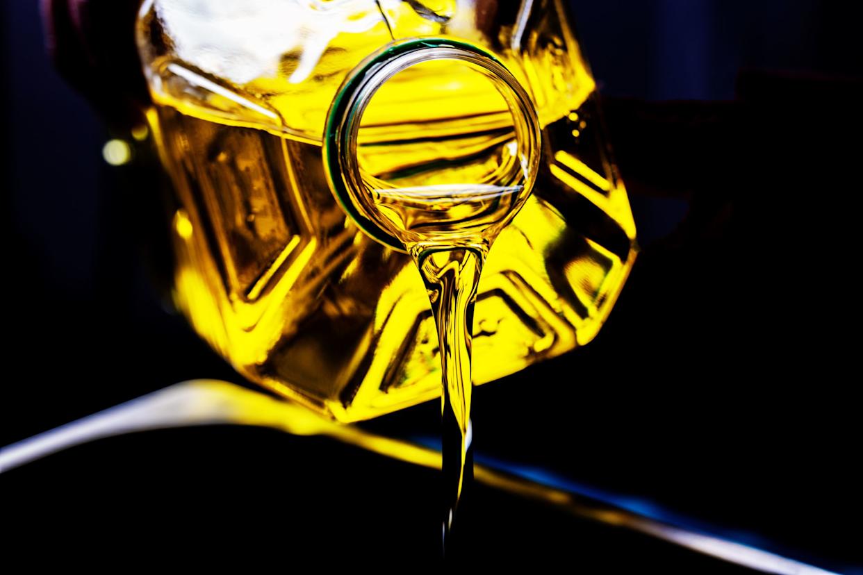 Pouring cooking oil from a plastic bottle