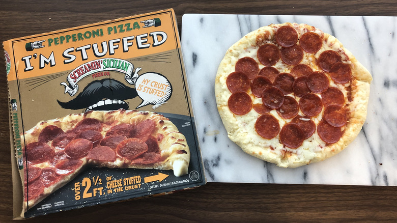 Screamin' Sicilian stuffed pepperoni pizza on a cutting board.