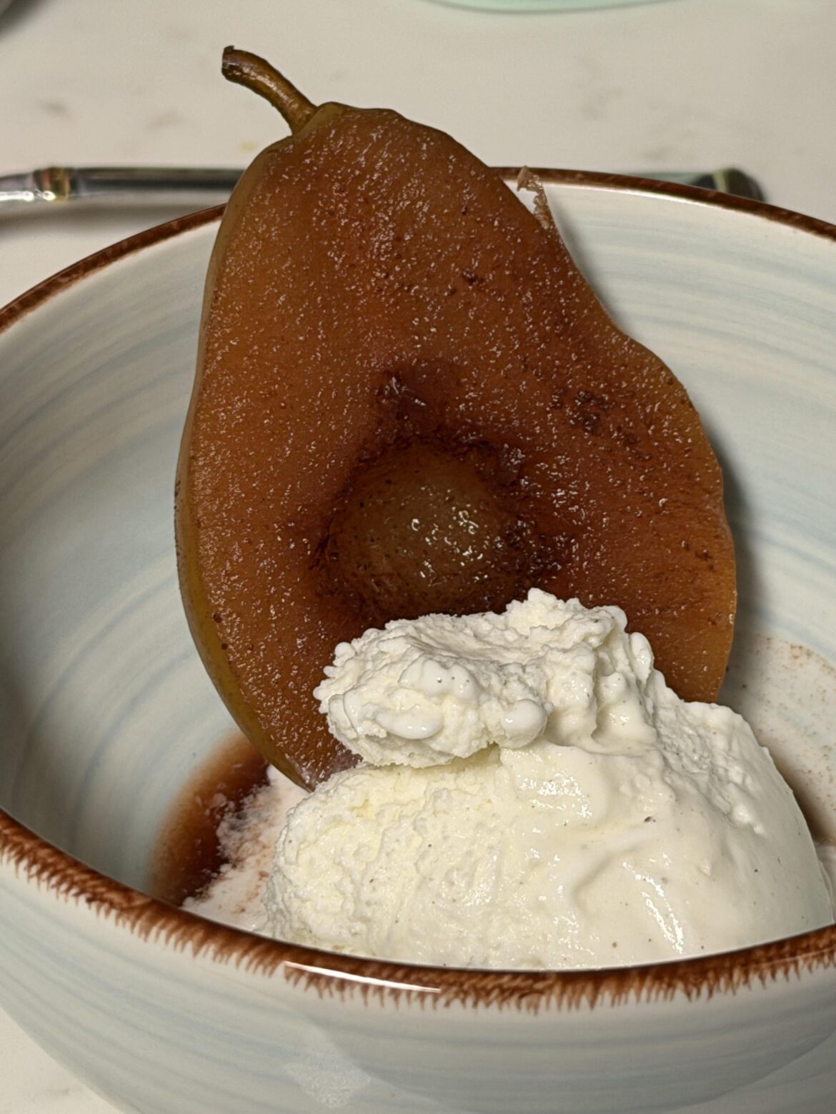 Poached pear with vanilla ice cream