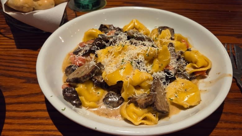 A plate of pasta on a table at Olive Garden