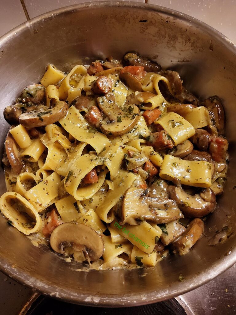 Calamarata with mushrooms, spicy salsiccia, onion, garlic, cream, white wine, parsley and black pepper