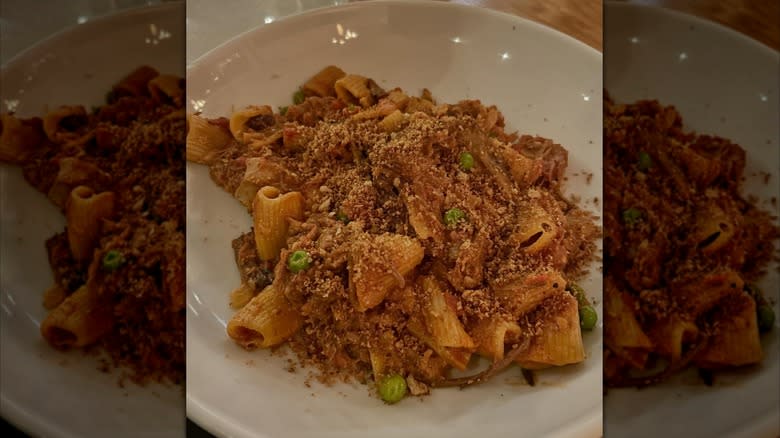 bowl of short rib pappardelle pasta topped with parmesan cheese