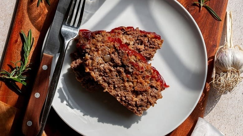 Meat loaf slices on plate with knife and fork