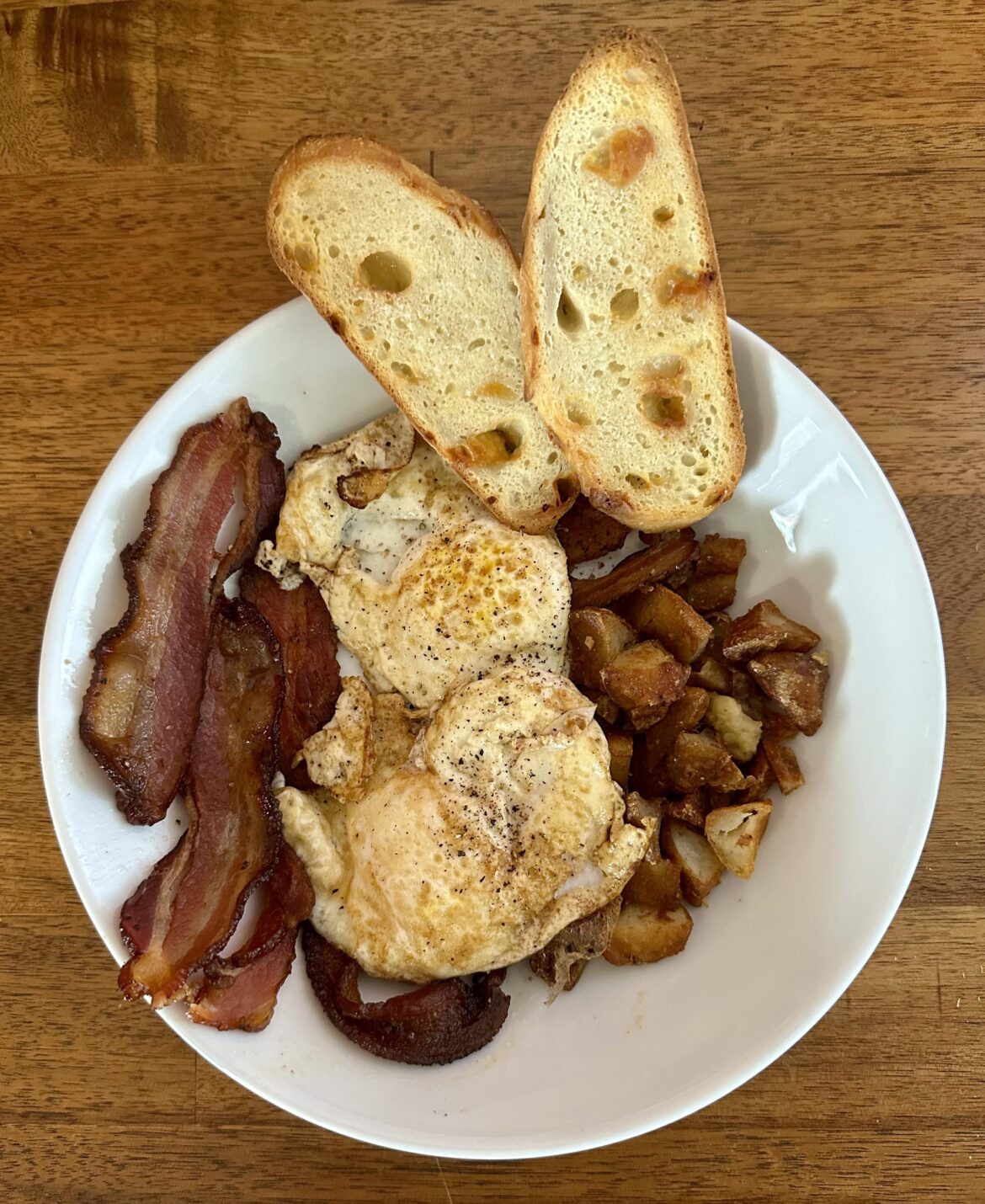 Over Easy Eggs on Potatoes and Bacon