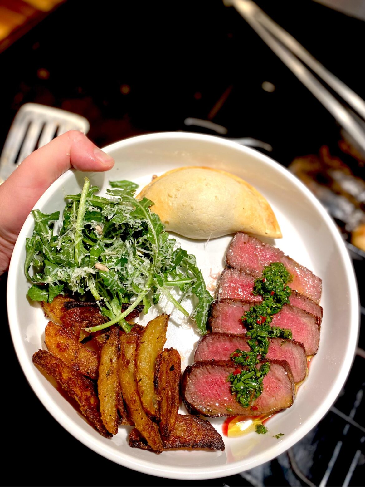 Steak with Chimichurri, Potato Wedges, Salad, and an Empanada [homemade]