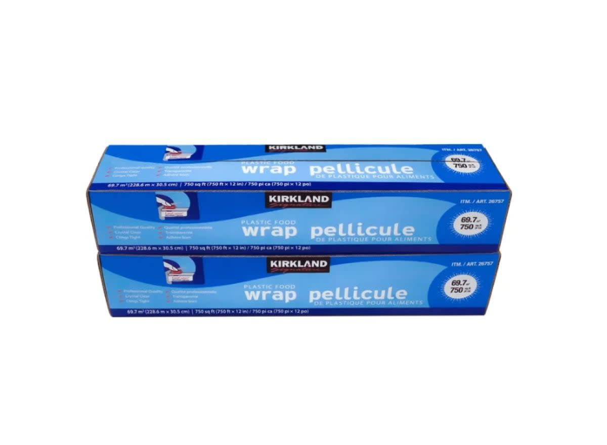 Two blue boxes of Kirkland plastic food wrap, each 30.16 cm x 231.03 m (750 sq ft), are stacked on top of each other against a white background.
