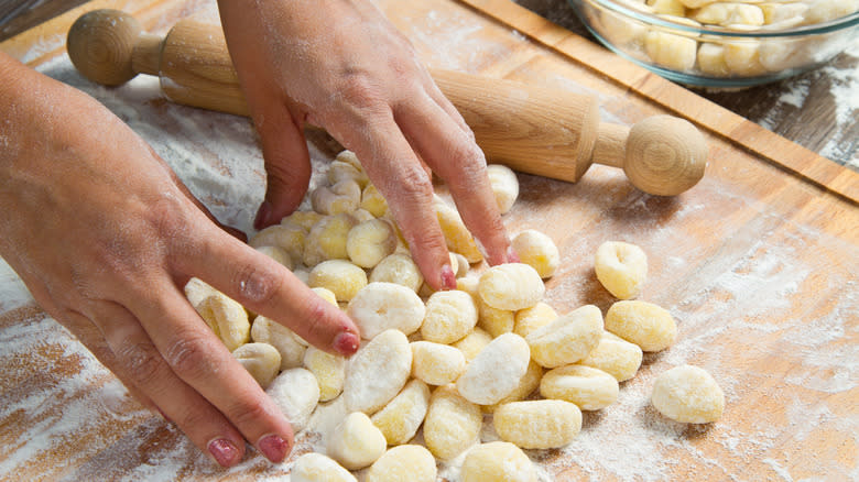 hands touching homemade fresh potato gnocchi