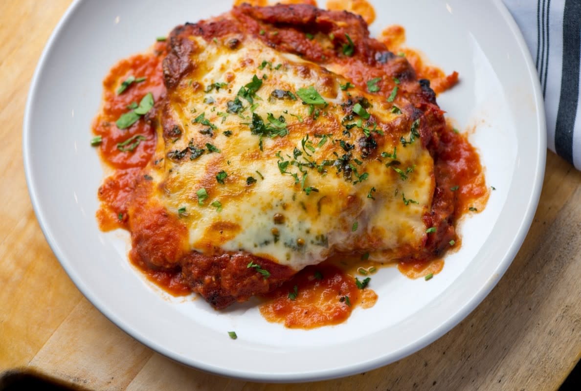 Classic chicken parmesan served with marinara and melted cheese.Image via Shutterstock&sol;RFondren Photography