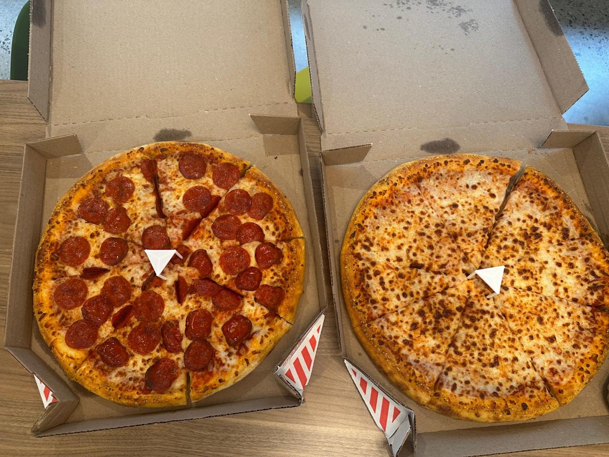 plain and pepperoni pizza from dominos in their boxes